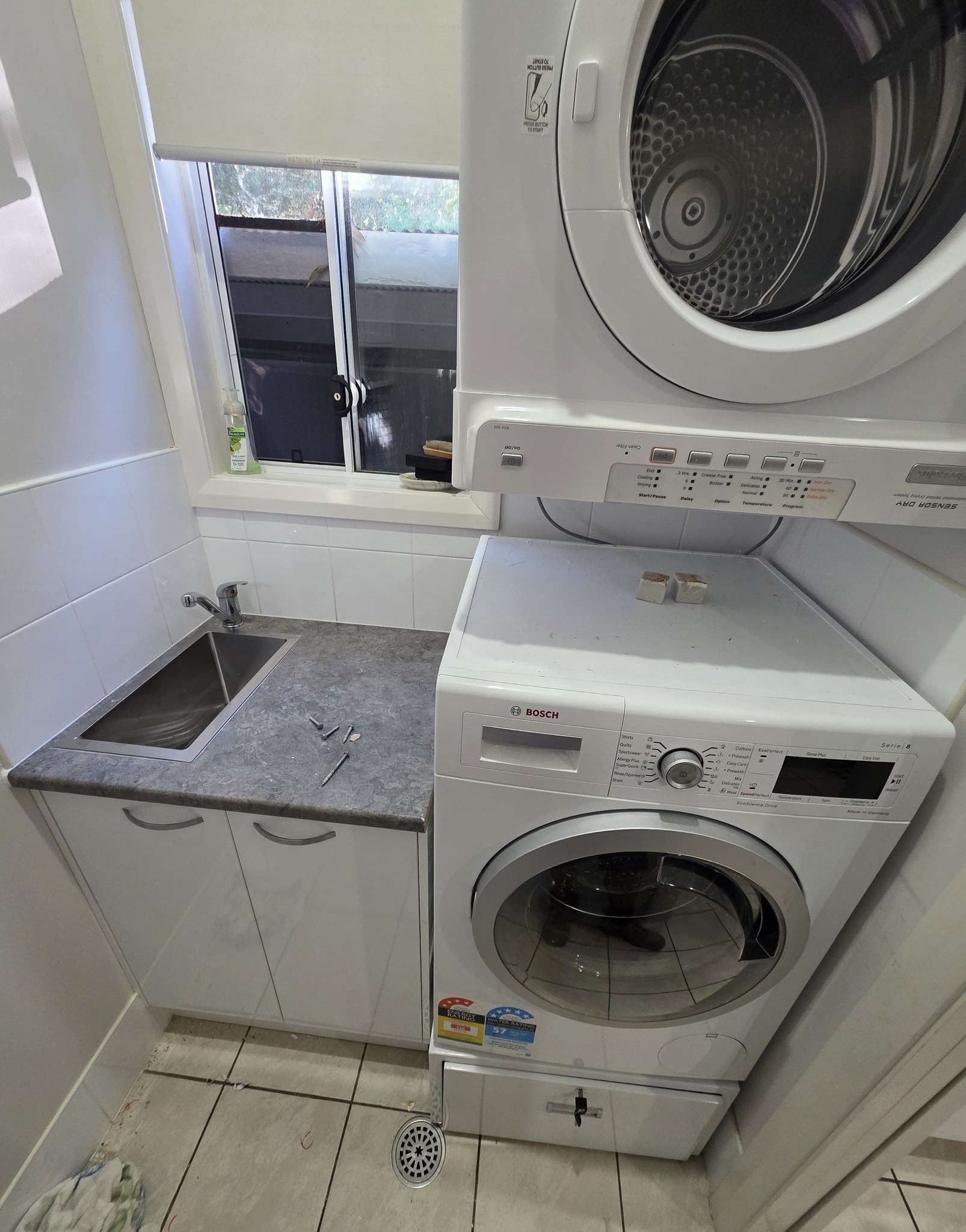 Laundry fit-out with stacked washer and dryer