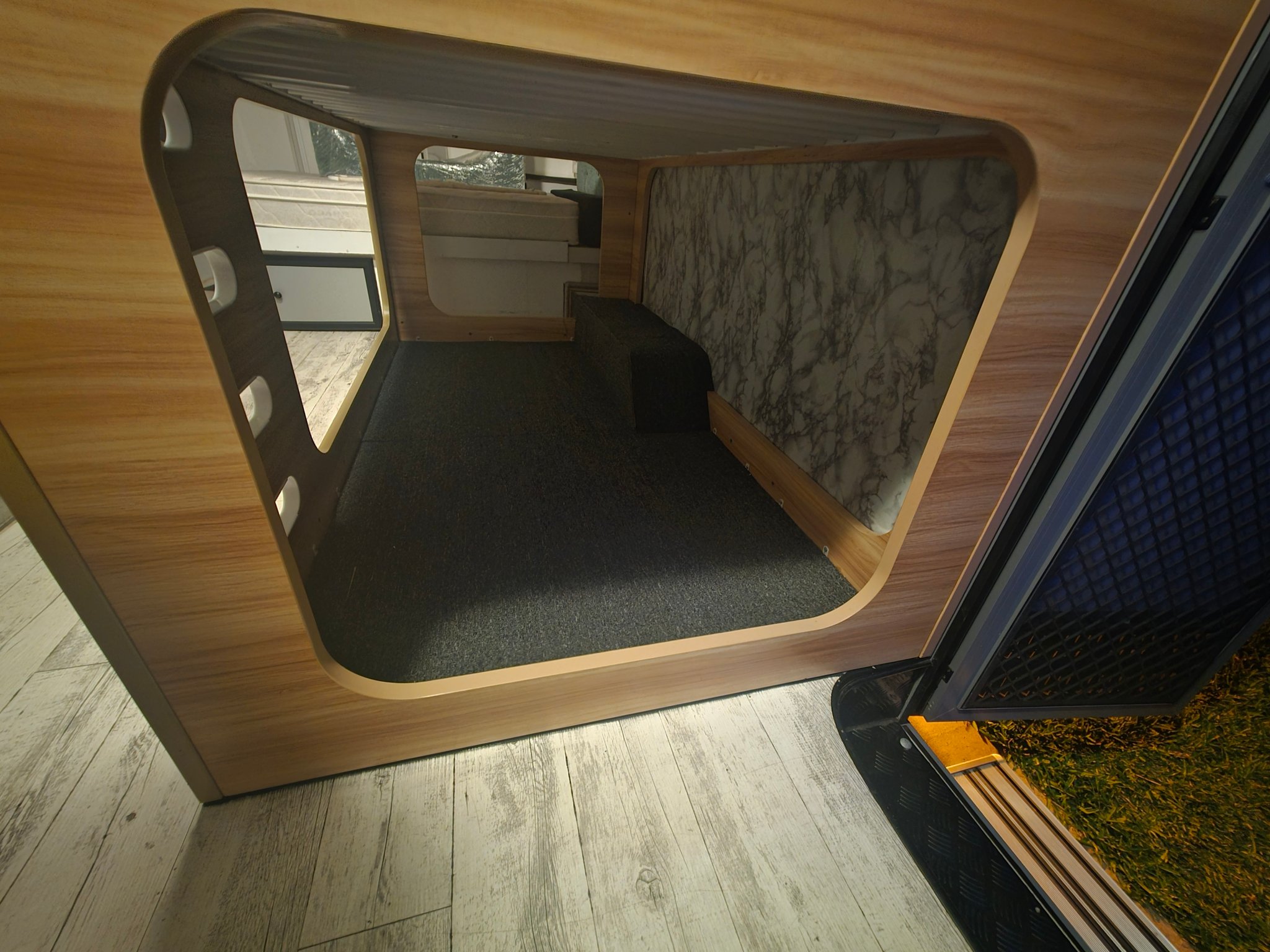Curved timber opening on a caravan bunk
