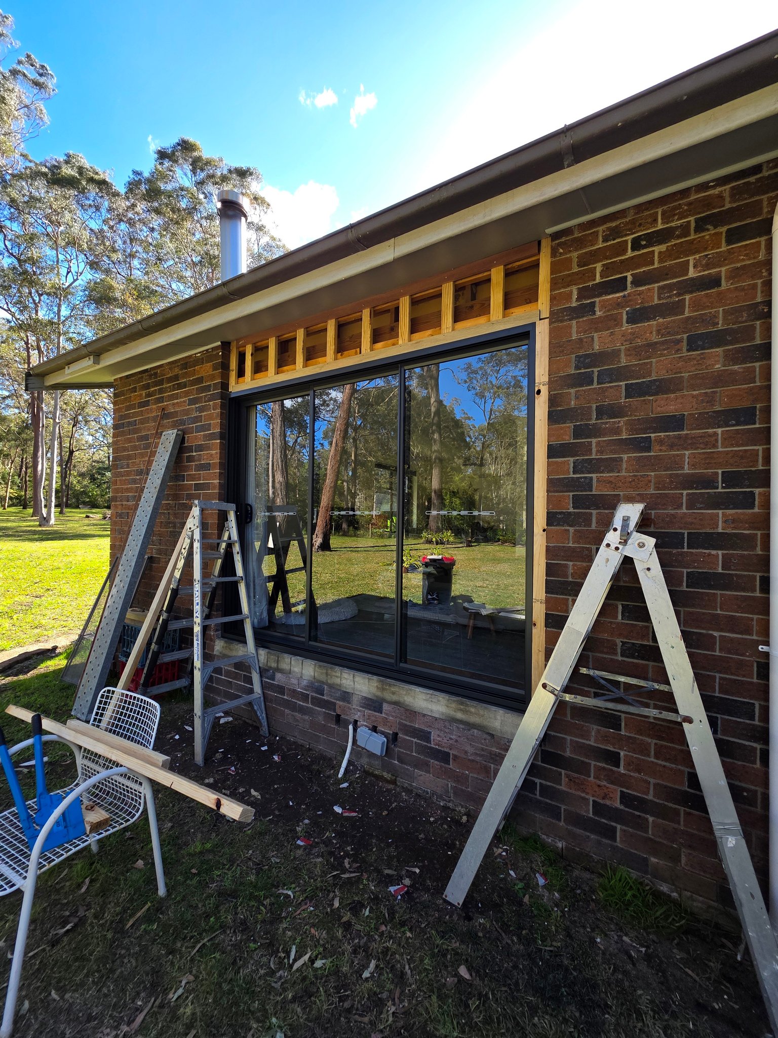 A new window frame going into a brick wall
