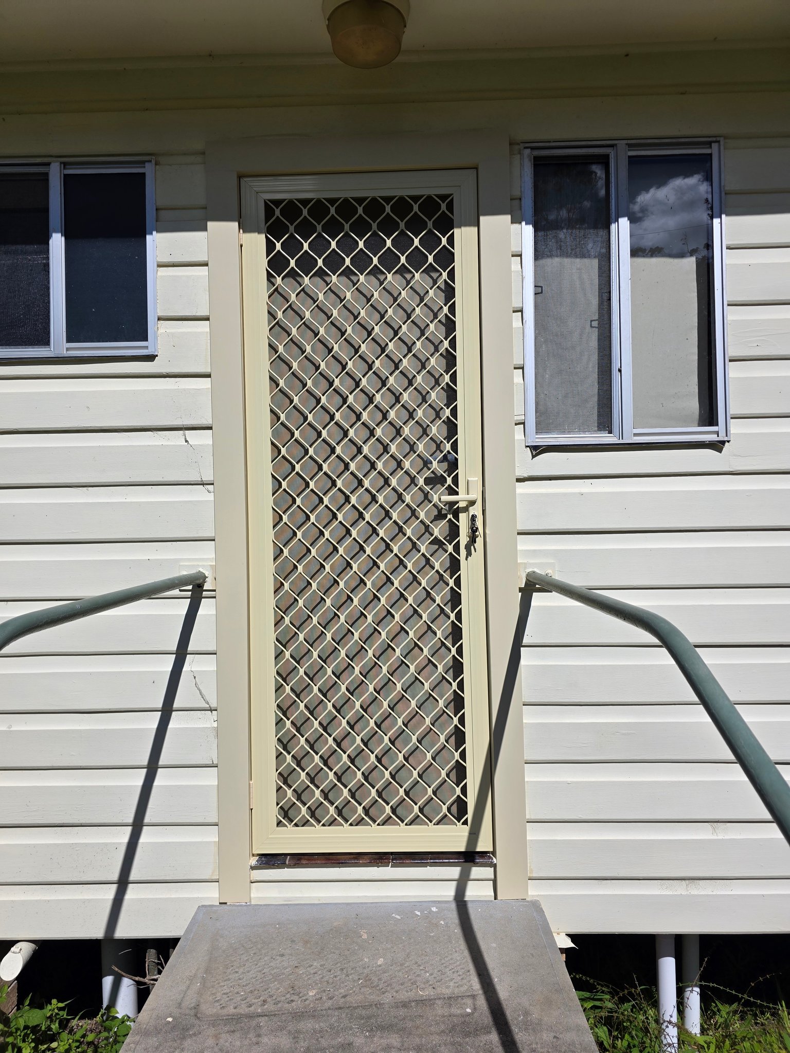New security screen door on a weatherboard house