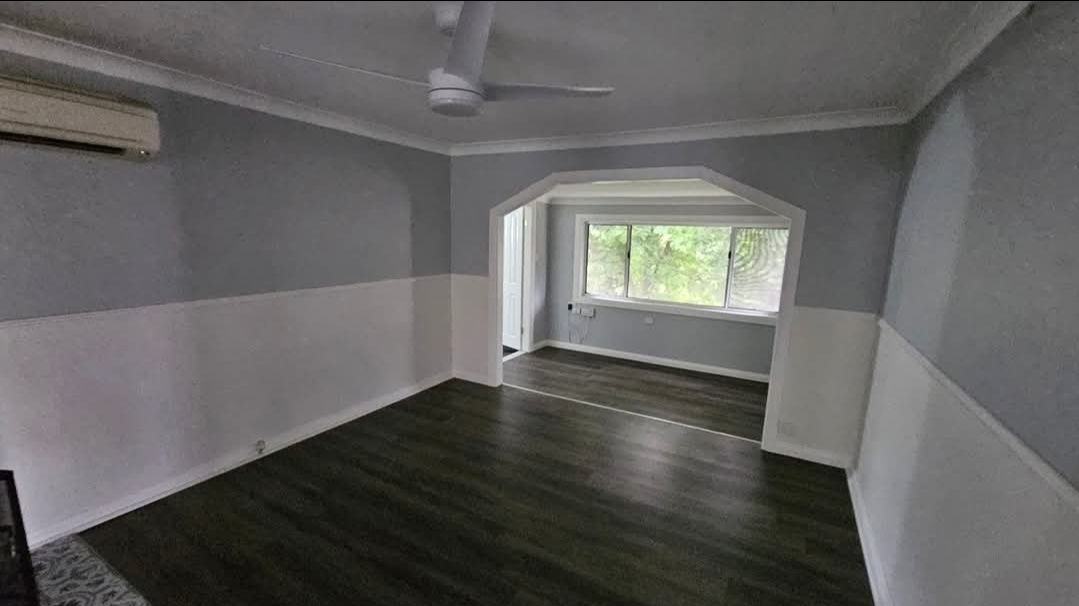 Renovated room with new dark flooring and fresh paint