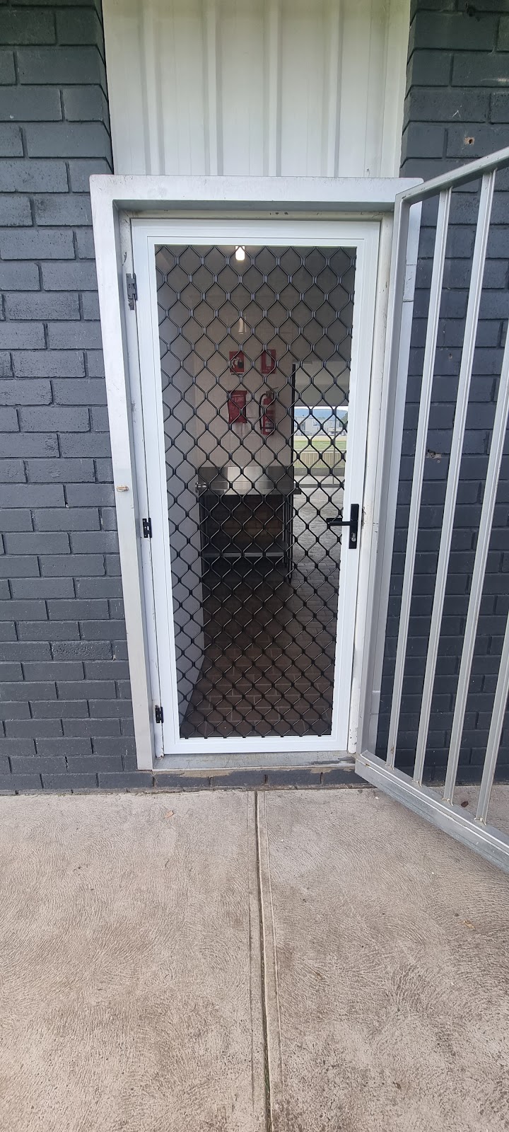 Security screen door fitted to a painted brick home